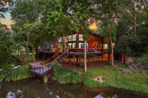 LUX Treehouse on Private Lake next to Lake Conroe with Game room, Paddleboards, Lake Views, and more!